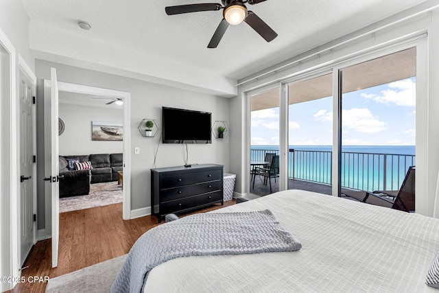 10519 Front Beach Rd Unit 1704B, Panama City Beach, FL 32407 - bedroom with access to exterior, wood finished floors, baseboards, and a ceiling fan