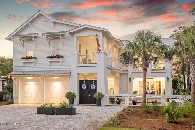 135 Buddy St, Santa Rosa Beach, FL 32459 - view of front of home featuring a balcony, decorative driveway, an attached garage, and stucco siding