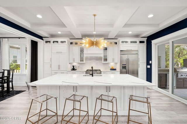135 Buddy St, Santa Rosa Beach, FL 32459 - kitchen featuring built in refrigerator, light wood-style floors, a chandelier, white cabinetry, and beam ceiling