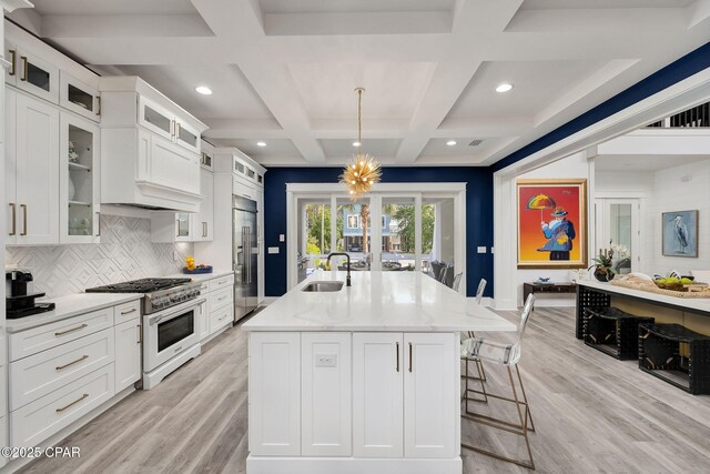 135 Buddy St, Santa Rosa Beach, FL 32459 - kitchen with premium appliances, a sink, light wood-type flooring, coffered ceiling, and light stone counters