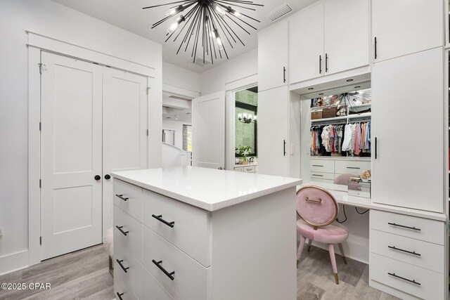135 Buddy St, Santa Rosa Beach, FL 32459 - spacious closet featuring a chandelier and light wood-type flooring