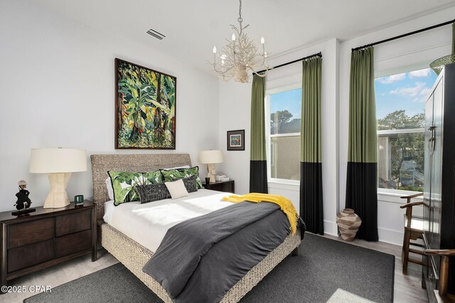 135 Buddy St, Santa Rosa Beach, FL 32459 - bedroom with a chandelier and wood finished floors