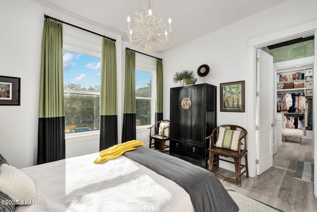135 Buddy St, Santa Rosa Beach, FL 32459 - bedroom featuring a chandelier, wood finished floors, and baseboards