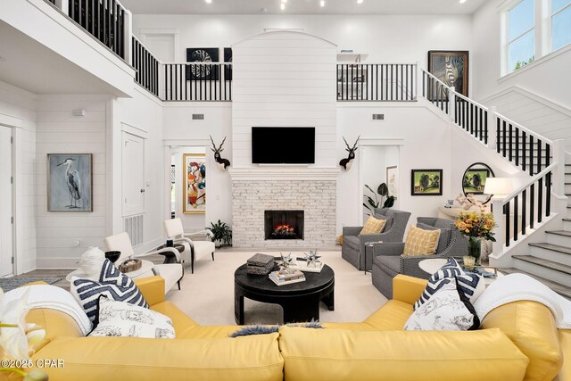 135 Buddy St, Santa Rosa Beach, FL 32459 - living room featuring a high ceiling, stairs, and a brick fireplace
