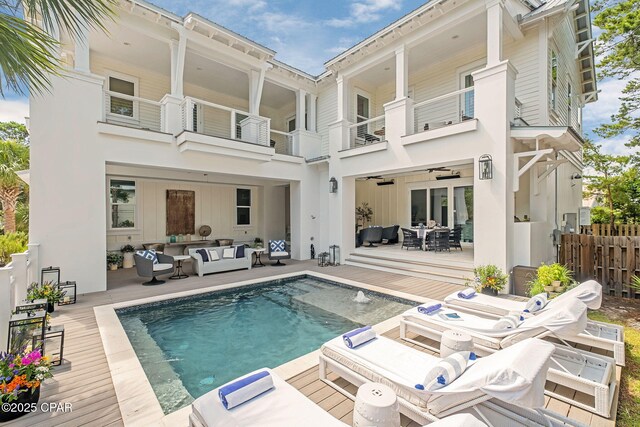 135 Buddy St, Santa Rosa Beach, FL 32459 - rear view of house featuring outdoor lounge area, a balcony, an outdoor pool, and a wooden deck