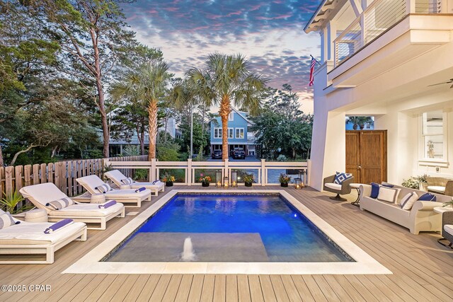 135 Buddy St, Santa Rosa Beach, FL 32459 - pool at dusk with a wooden deck and an outdoor living space