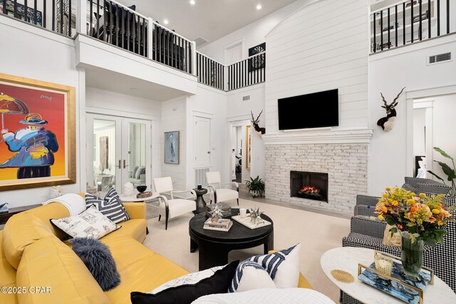 135 Buddy St, Santa Rosa Beach, FL 32459 - living room with a towering ceiling, a fireplace, french doors, and recessed lighting