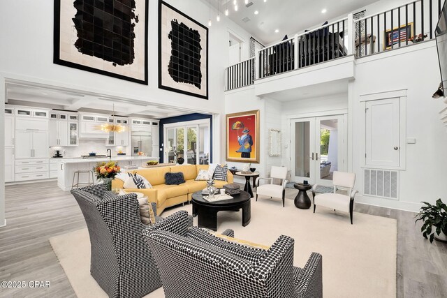 135 Buddy St, Santa Rosa Beach, FL 32459 - living area with healthy amount of natural light, light wood-style floors, french doors, a high ceiling, and recessed lighting