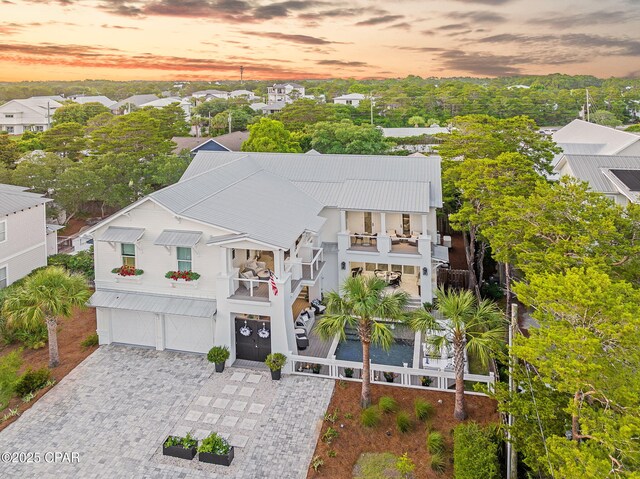 135 Buddy St, Santa Rosa Beach, FL 32459 - view of front facade with a balcony, an attached garage, decorative driveway, and stairs