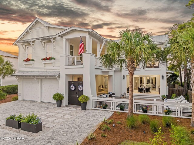 135 Buddy St, Santa Rosa Beach, FL 32459 - view of front of home with a balcony, a garage, decorative driveway, and stucco siding