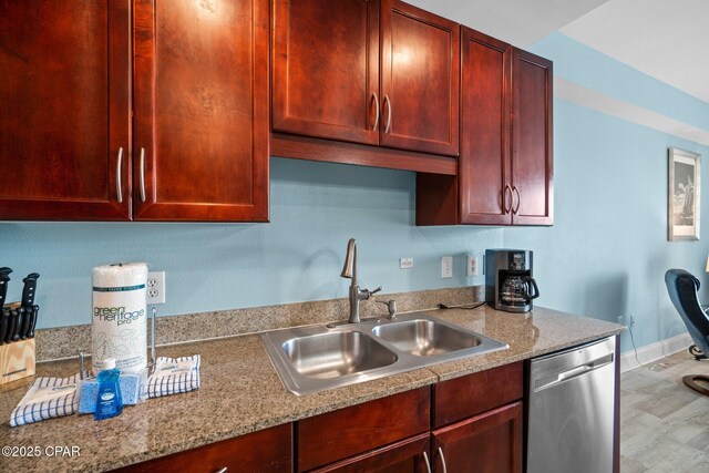 9902 S Thomas Dr Unit 135, Panama City Beach, FL 32408 - kitchen with dishwasher, a sink, dark brown cabinets, baseboards, and light stone counters