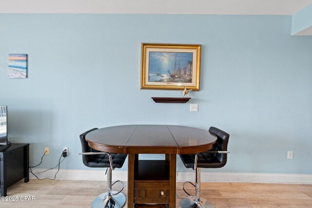 9902 S Thomas Dr Unit 135, Panama City Beach, FL 32408 - dining space with baseboards and wood finished floors