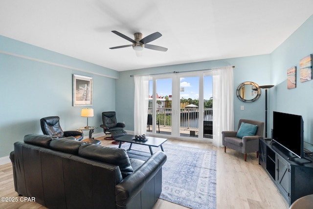 9902 S Thomas Dr Unit 135, Panama City Beach, FL 32408 - living area with light wood-style floors, a ceiling fan, and baseboards