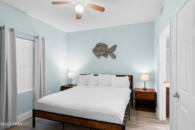 9902 S Thomas Dr Unit 135, Panama City Beach, FL 32408 - bedroom featuring light wood-style floors, baseboards, and ceiling fan