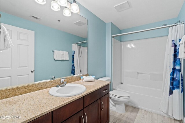 9902 S Thomas Dr Unit 135, Panama City Beach, FL 32408 - full bath featuring wood finished floors, vanity, toilet, and shower / bathtub combination with curtain