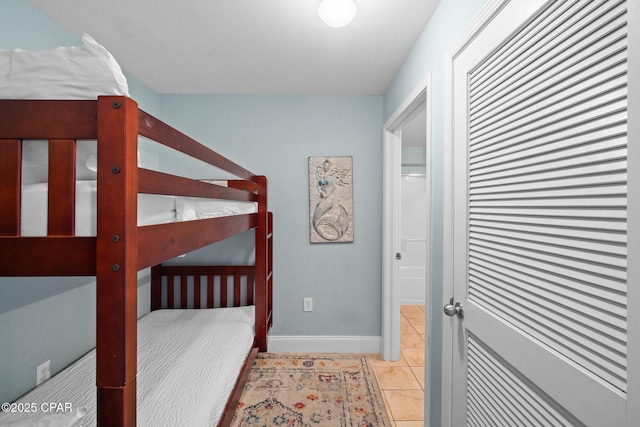 9902 S Thomas Dr Unit 135, Panama City Beach, FL 32408 - bedroom with light tile patterned flooring, baseboards, and a closet