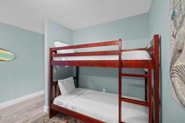 9902 S Thomas Dr Unit 135, Panama City Beach, FL 32408 - bedroom with wood finished floors and baseboards