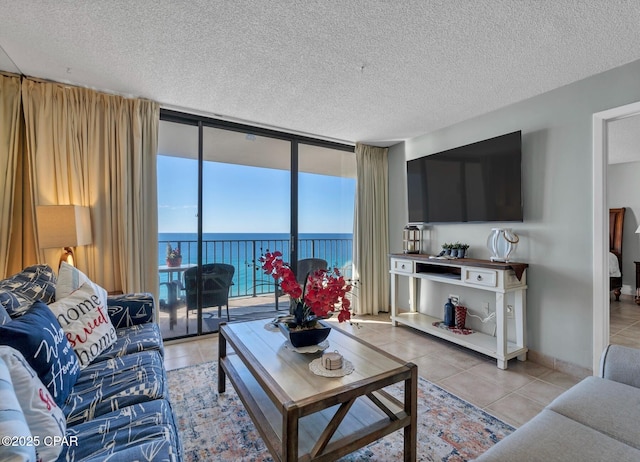 11619 Front Beach Rd Unit 1110, Panama City Beach, FL 32407 - living room with light tile patterned flooring, a textured ceiling, and expansive windows