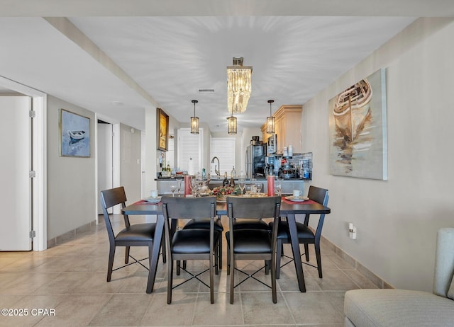 11619 Front Beach Rd Unit 1110, Panama City Beach, FL 32407 - dining room featuring light tile patterned floors and a chandelier