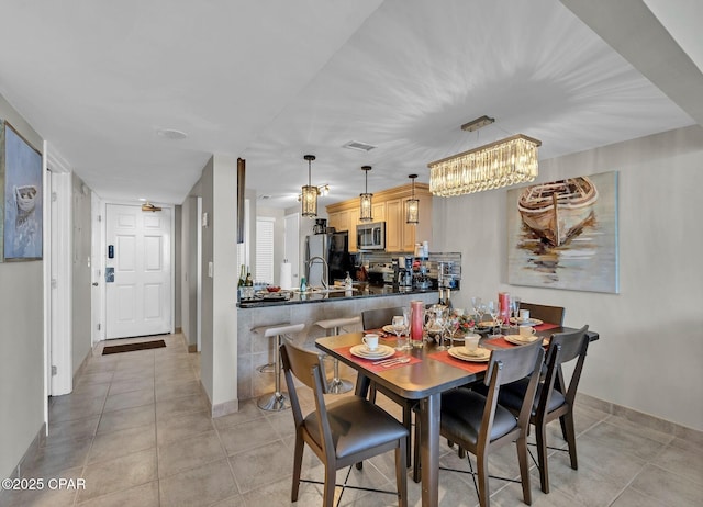 11619 Front Beach Rd Unit 1110, Panama City Beach, FL 32407 - dining area featuring light tile patterned floors, a chandelier, and baseboards
