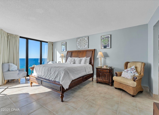 11619 Front Beach Rd Unit 1110, Panama City Beach, FL 32407 - bedroom featuring a textured ceiling, a water view, and light tile patterned floors