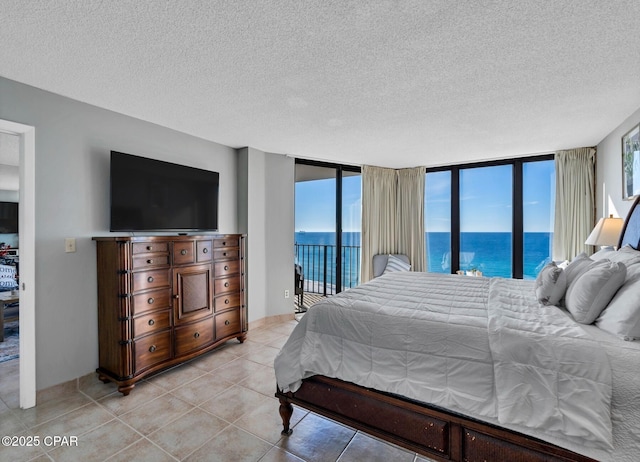 11619 Front Beach Rd Unit 1110, Panama City Beach, FL 32407 - bedroom with access to exterior, a textured ceiling, and light tile patterned flooring