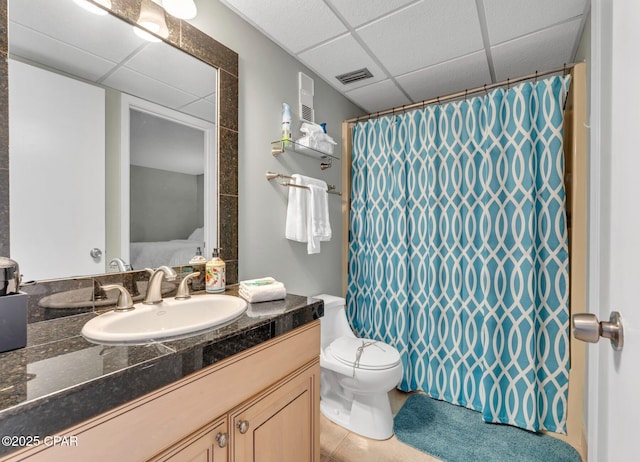 11619 Front Beach Rd Unit 1110, Panama City Beach, FL 32407 - ensuite bathroom featuring a paneled ceiling, vanity, toilet, tile patterned flooring, and a shower with shower curtain