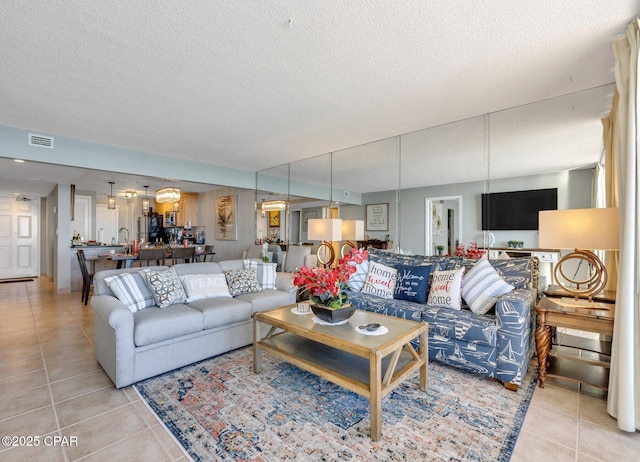 11619 Front Beach Rd Unit 1110, Panama City Beach, FL 32407 - living room featuring light tile patterned flooring and a textured ceiling