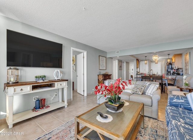 11619 Front Beach Rd Unit 1110, Panama City Beach, FL 32407 - living area featuring light tile patterned floors, a textured ceiling, and baseboards