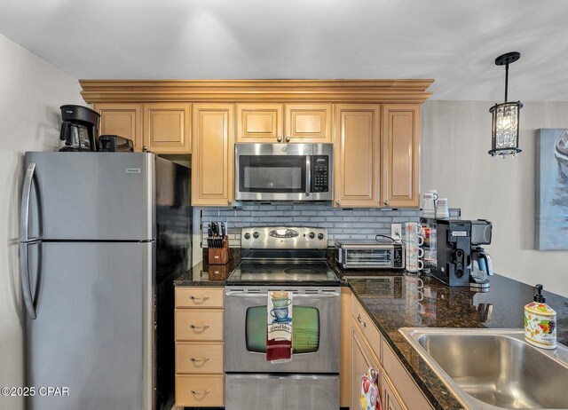 11619 Front Beach Rd Unit 1110, Panama City Beach, FL 32407 - kitchen with stainless steel appliances, a sink, backsplash, and decorative light fixtures