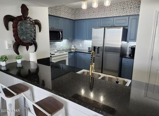 14701 Front Beach Rd Unit 1727, Panama City Beach, FL 32413 - kitchen featuring appliances with stainless steel finishes, blue cabinets, backsplash, and a sink