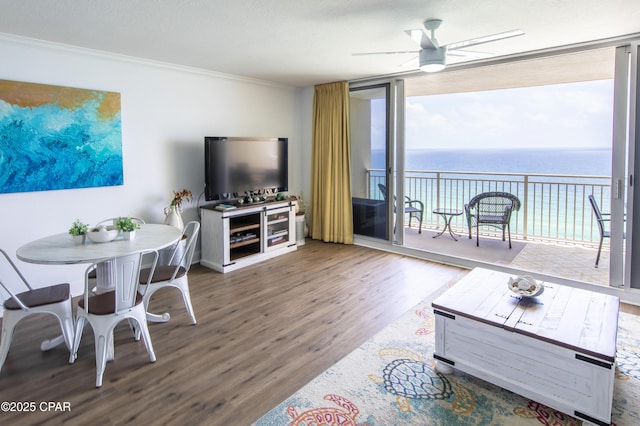 14701 Front Beach Rd Unit 1727, Panama City Beach, FL 32413 - living area with wood finished floors, ornamental molding, ceiling fan, and a wall of windows