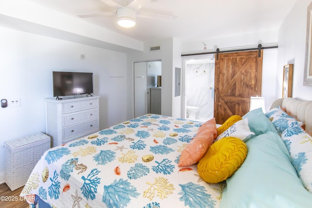 14701 Front Beach Rd Unit 1727, Panama City Beach, FL 32413 - bedroom with a barn door, wood finished floors, ensuite bathroom, and ceiling fan