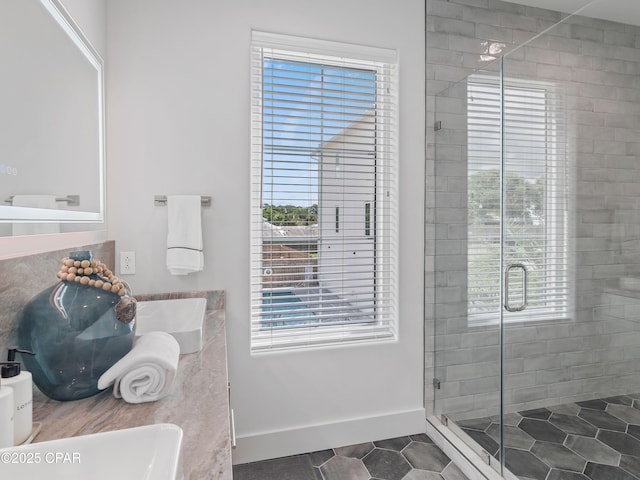 101 Deluna Pl Unit C, Panama City Beach, FL 32413 - bathroom with a stall shower, tile patterned flooring, and double vanity