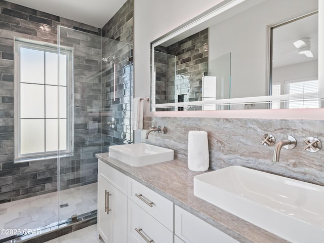 101 Deluna Pl Unit C, Panama City Beach, FL 32413 - bathroom with a stall shower, double vanity, and decorative backsplash