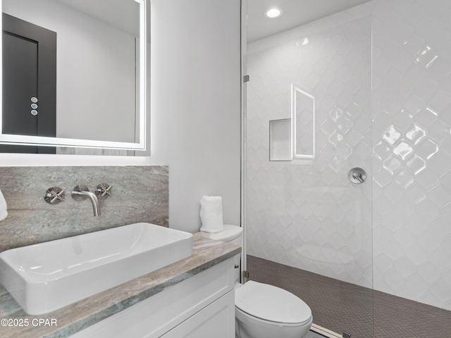 101 Deluna Pl Unit C, Panama City Beach, FL 32413 - full bathroom featuring a tile shower, toilet, vanity, and recessed lighting
