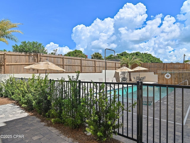 101 Deluna Pl Unit C, Panama City Beach, FL 32413 - community pool with a fenced backyard and a patio