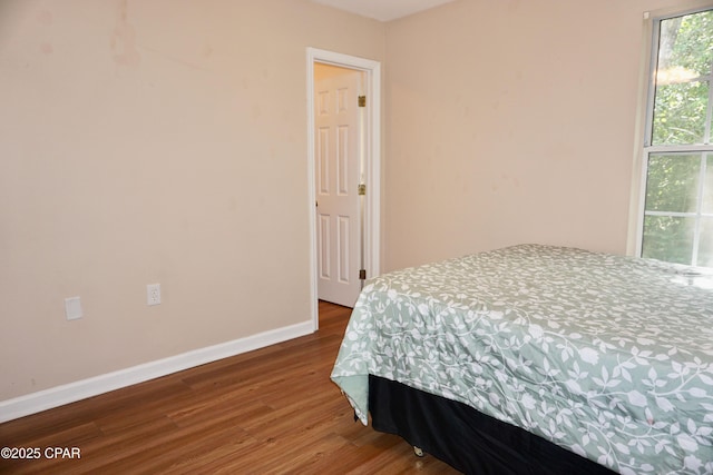 2738 W Tharpe St Unit 1103, Tallahassee, FL 32303 - bedroom featuring wood finished floors and baseboards