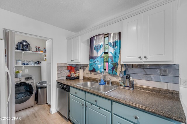 4331 Garrison Rd, Panama City, FL 32404 - kitchen featuring washer / clothes dryer, dishwasher, blue cabinetry, a sink, and a textured ceiling
