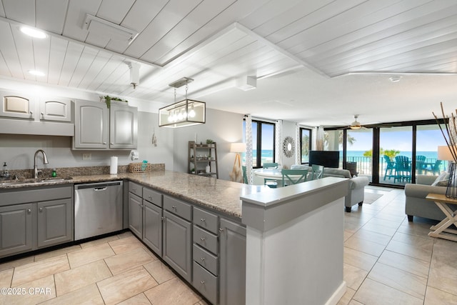6201 Thomas Dr Unit 202, Panama City Beach, FL 32408 - kitchen featuring gray cabinetry, a sink, dishwasher, a peninsula, and open floor plan