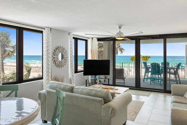 6201 Thomas Dr Unit 202, Panama City Beach, FL 32408 - living area with ceiling fan, a textured ceiling, and light tile patterned flooring