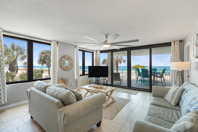 6201 Thomas Dr Unit 202, Panama City Beach, FL 32408 - living area with a ceiling fan, a textured ceiling, and baseboards