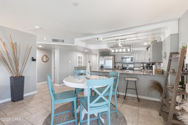 6201 Thomas Dr Unit 202, Panama City Beach, FL 32408 - dining space with a textured ceiling, baseboards, and recessed lighting