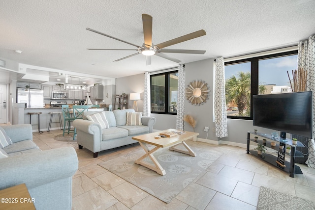 6201 Thomas Dr Unit 202, Panama City Beach, FL 32408 - living area featuring a ceiling fan, a textured ceiling, and light tile patterned flooring