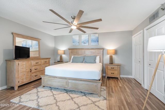 6201 Thomas Dr Unit 202, Panama City Beach, FL 32408 - bedroom featuring wood finished floors, baseboards, and a ceiling fan