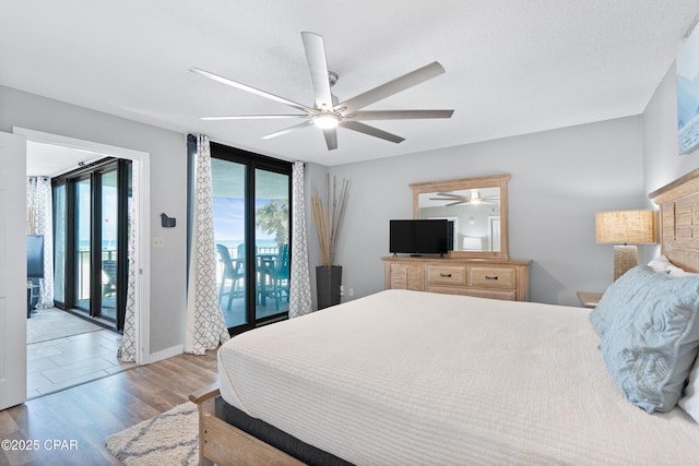 6201 Thomas Dr Unit 202, Panama City Beach, FL 32408 - bedroom with access to exterior, wood finished floors, and ceiling fan