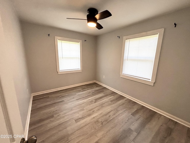 811 Mcgee Rd, Bonifay, FL 32425 - spare room featuring ceiling fan, wood finished floors, and baseboards