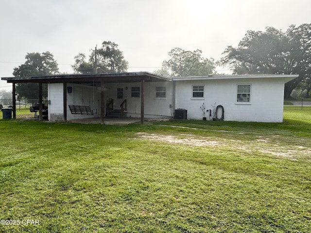 811 Mcgee Rd, Bonifay, FL 32425 - rear view of property with a lawn, a patio area, and central AC