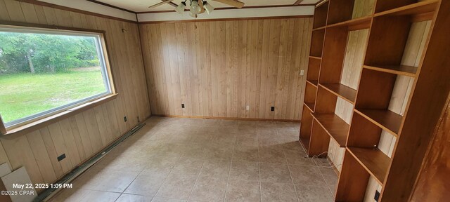 1006 N Church Ave, Panama City, FL 32401 - spare room with wood walls, ceiling fan, baseboard heating, baseboards, and light tile patterned floors