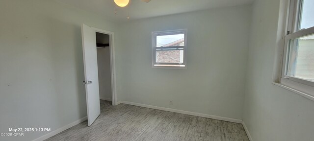 1006 N Church Ave, Panama City, FL 32401 - unfurnished bedroom featuring multiple windows, baseboards, light wood-type flooring, and a closet